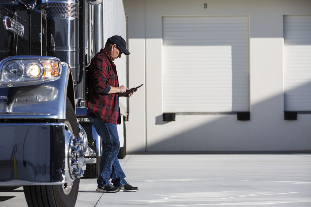 Truck driver looking at tablet