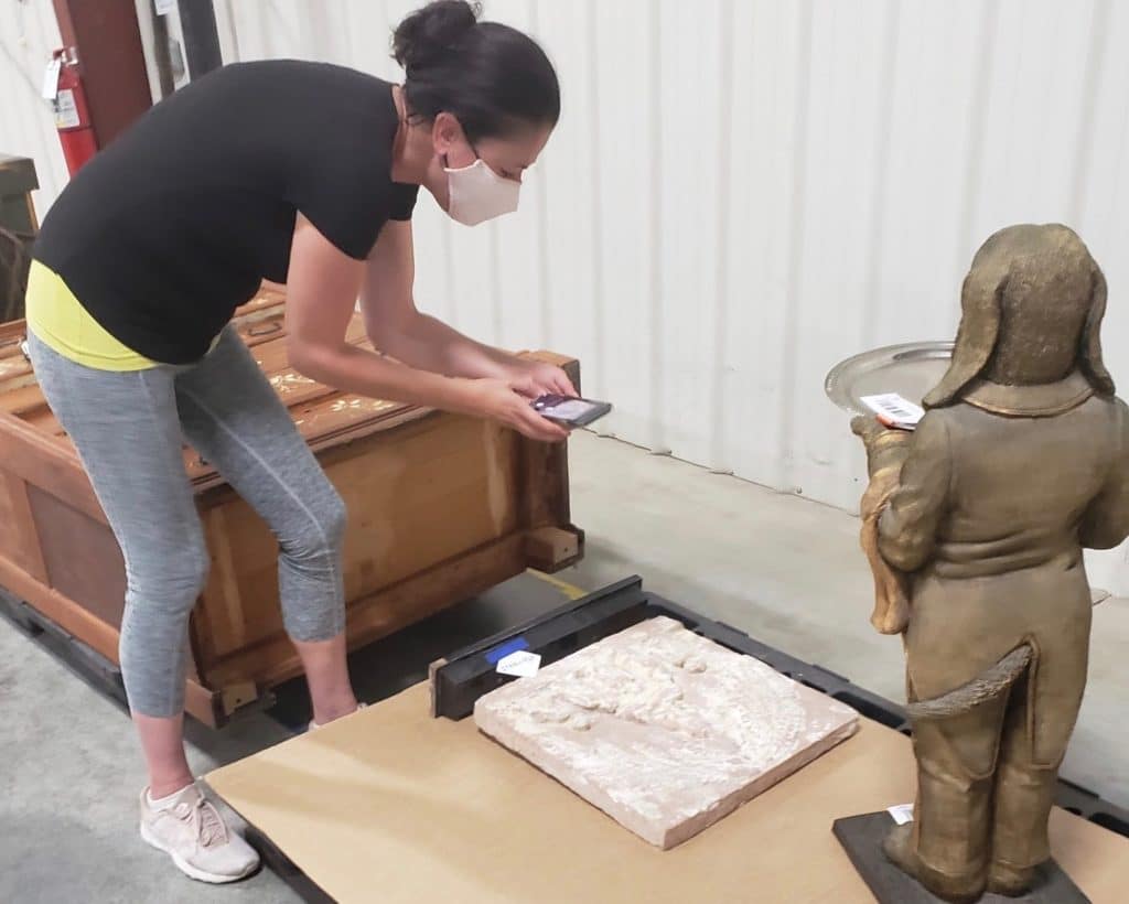 woman transporter taking photo of shipment for digital bill of lading