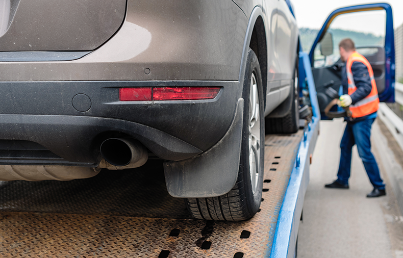 closeup of car on open trailer 