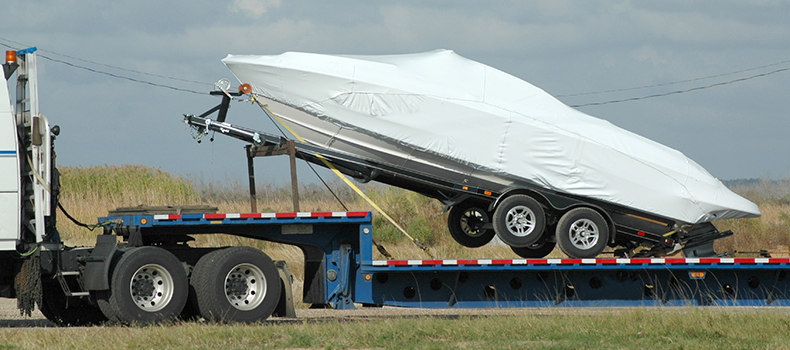 boat in transit on open trailer - boat transport insurance 