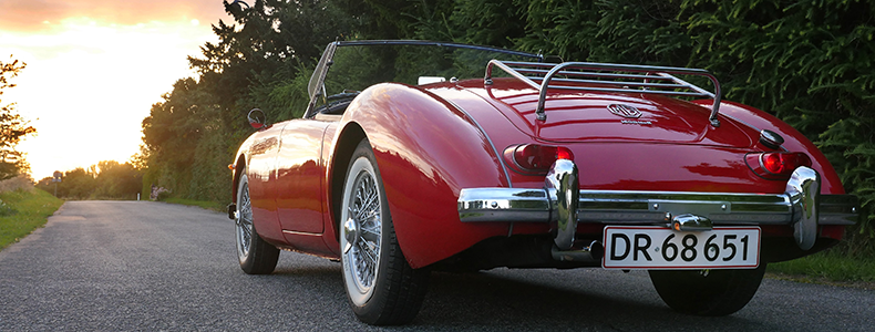 red classic car on the open road