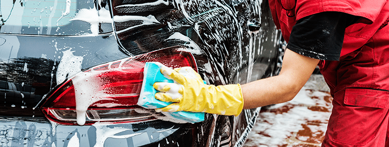 Someone preparing a vehicle for car shipping service