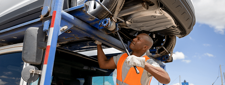 Auto transport carrier securing a vehicle to his trailer