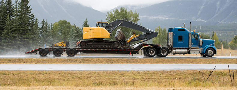 heavy equipment transport on flatbed