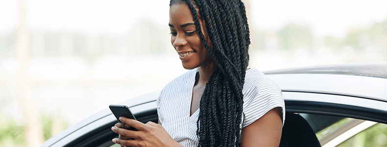 Woman reading customer reviews of Auto Transport Carrier