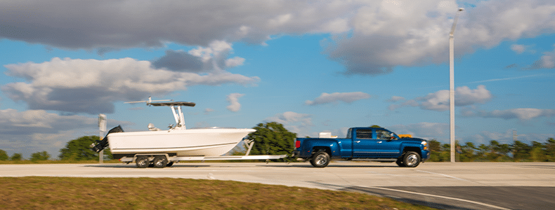 Motor boat on truck trailer for boat shipping