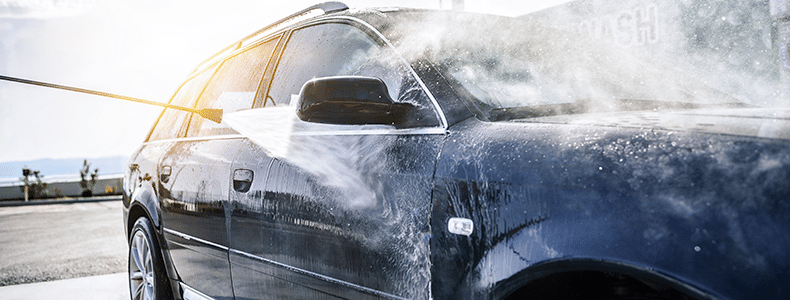 Person cleaning car before vehicle shipping