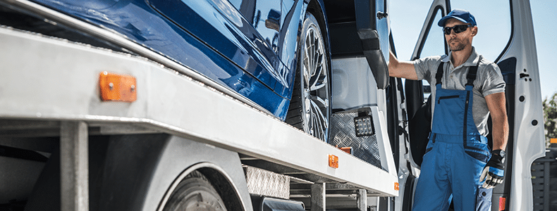carrier loading vehicle on open trailer