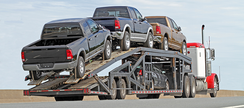Vehicles on open trailer covered by car shipping insurance