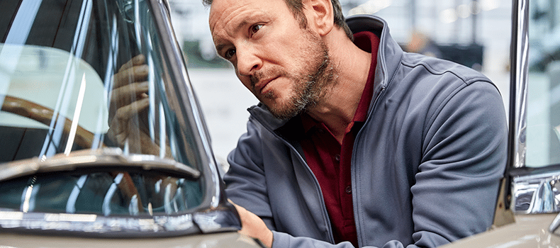 man checking vehicle for car shipping damage