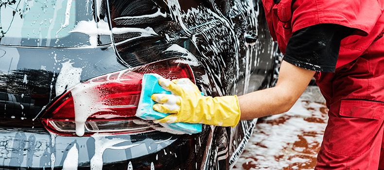 Someone washing their car as they prepare to ship a vehicle