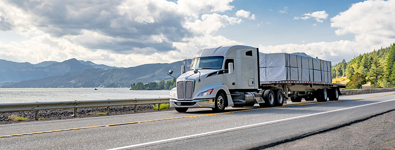 flatbed trailer transporting a load on open road