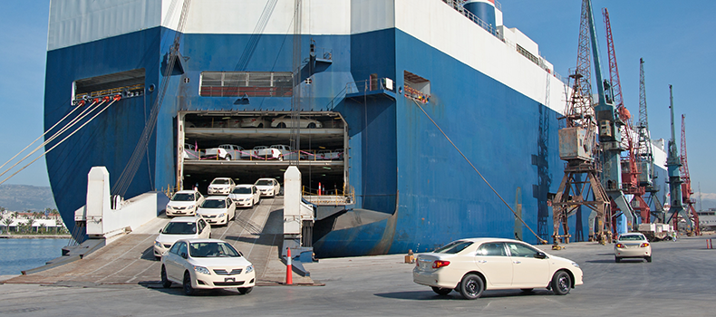 vehicles being unloaded at port after international car shipping